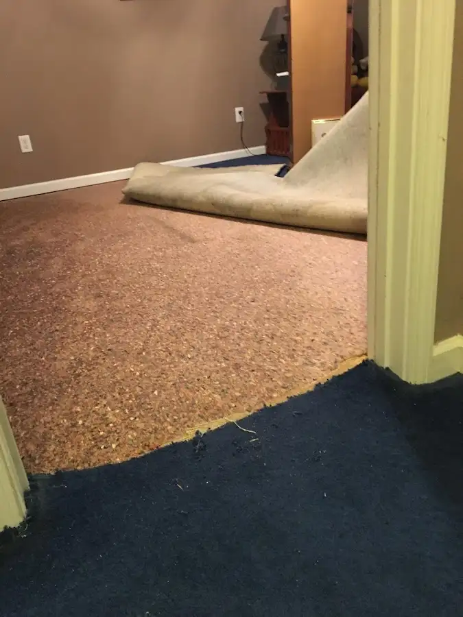 Carpet pad removal revealing water damage during Drying & Dehumidification in Twin Lakes